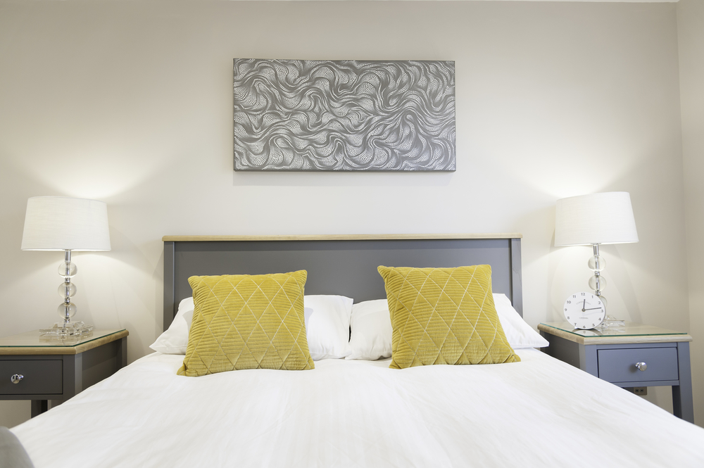 Comfy double bed with a unique painting above