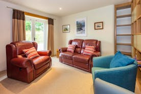 Orchard House bright sung with patio doors and a large bookcase for relaxing time with family and friends holiday accommodation - www.bhhl.co.uk
