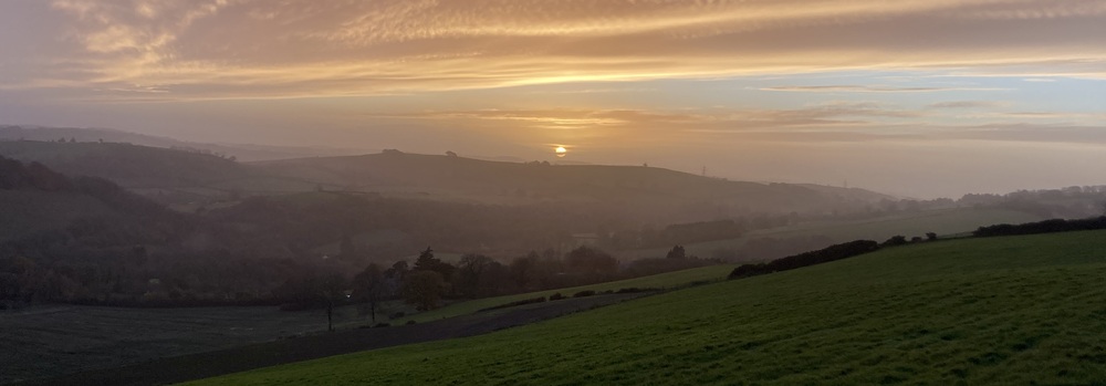 Sunset with view of hills and valley