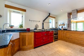 Large open kitchen featuring a large red Aga Belfast sink ideal space for self catering holidays in Monmouthshire wwwbhhl.co.uk