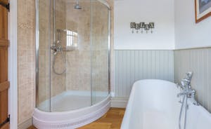 Frog Street: The Orchard Suite bathroom has a roll top bath and a shower cubicle