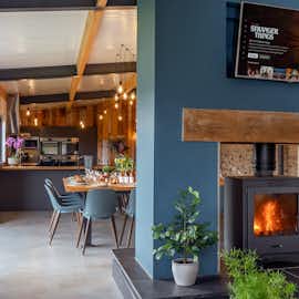 Hares Barton - A double-sided wood-burner brings a cosy glow on colder days  Hares Barton - A double-sided wood-burner brings a cosy glow on colder days