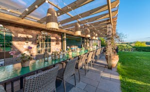 The gorgeous terrace with green mosaic tables and seating for 20