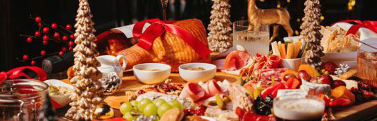 A table laden with Christmas food and drink