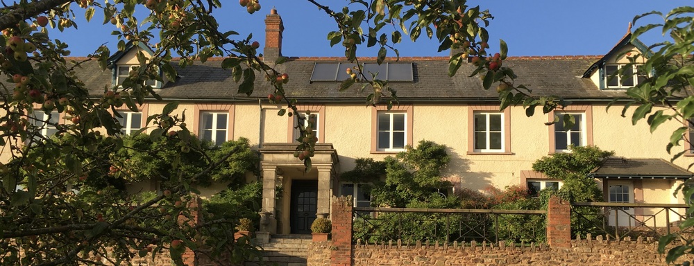 Hurstone House, with golden light of autumn and crabapples on the trees 