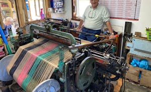 Donald J Mackay weaves Harris Tweed at Luskentyre with loom connected to Hamarsay House.