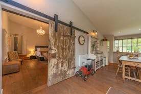 Court Farm - The Cider Barn: An original sliding barn door leads through to the bedroom
