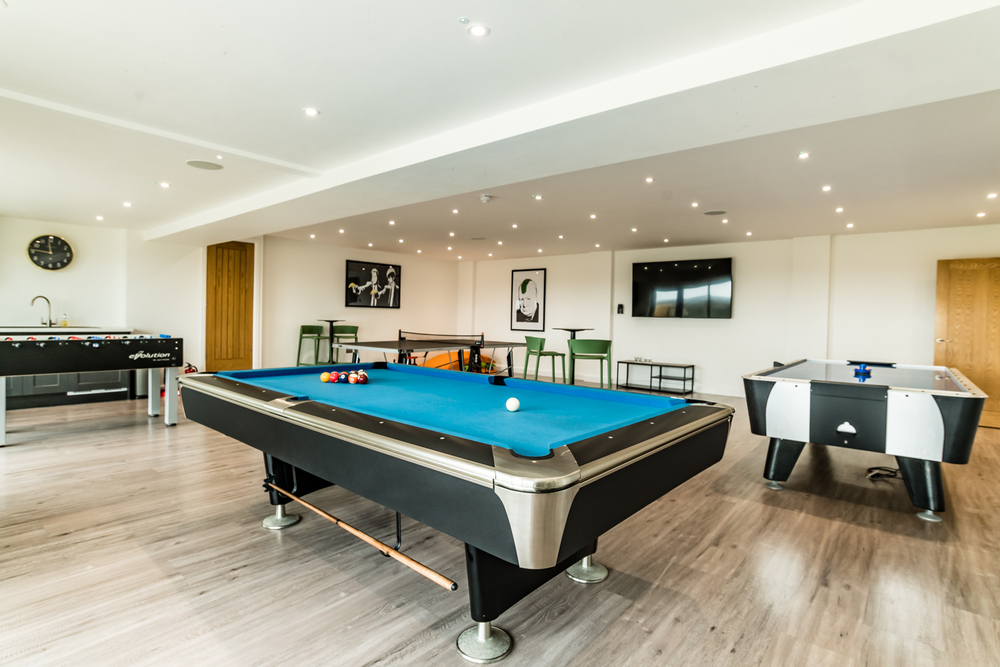 Churchill games room equipped with pool table table tennis table football and air hockey