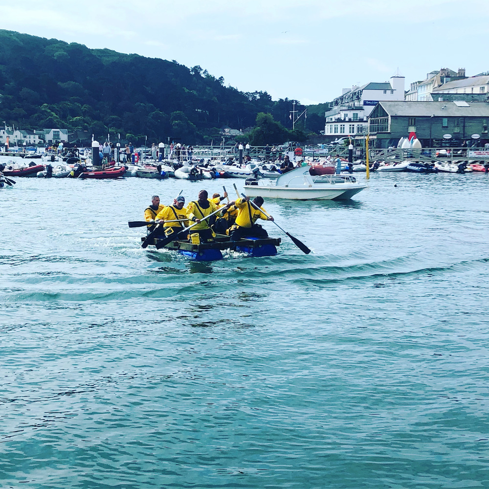 A group taking part in an exciting rowing water sports activity in somewhere around Devon