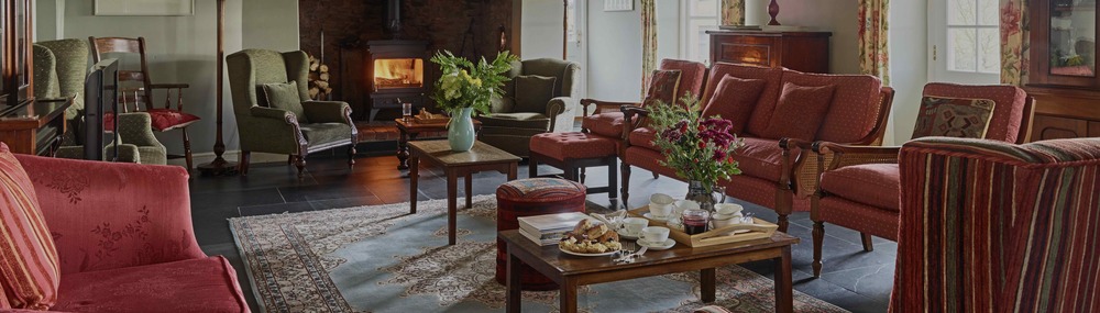 Spacious sitting room, afternoon tea on the table ready to be served 