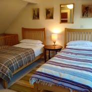 Spacious twin bedroom with cot