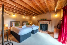 Dancing Hill - Bedroom 6: On the ground floor, with beams and a feature fireplace