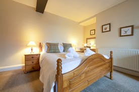 A pine double bed in a modern clean bedroom at Forest House, an 11 bed, whole house holiday let in Coleford - www.bhhl.co.uk