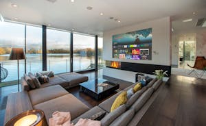 The Glass House - The living room; sunken sofas, a projection wall, stunning views 